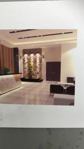 a living room with a couch and a table at KLUANG RIVERVIEW HOTEL in Kluang