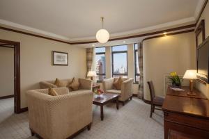 a living room with a couch and chairs and a table at Jin Jiang Park Hotel in Shanghai