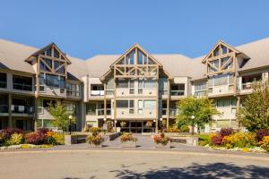 an apartment building with flowers in the courtyard at Greystone Lodge 314&315 in Whistler
