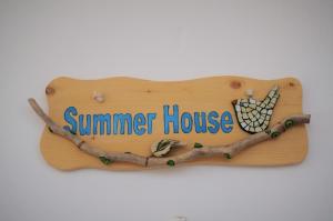 a wooden sign with a summer house on it at Summer Residence in Provatas