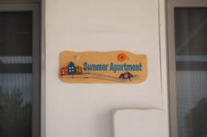 a wooden sign on a door with a train on it at Summer Residence in Provatas