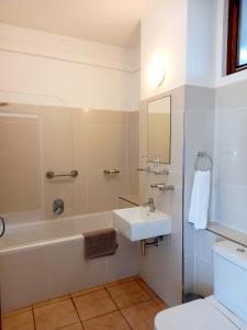 a bathroom with a sink and a shower and a toilet at Salt Rock Hotel and Beach Resort in Ballito