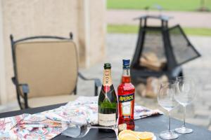 two bottles of wine sitting on a table with glasses at Die Remise Halla in Stolpe +11 photos