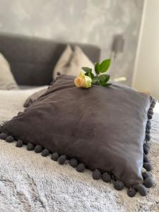 a pillow with a flower on top of it on a bed at Schusterhof Dölsach in Dölsach