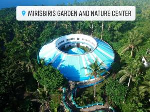 a blue building in the middle of the forest at Mirisbiris Garden and Nature Center in Santo Domingo