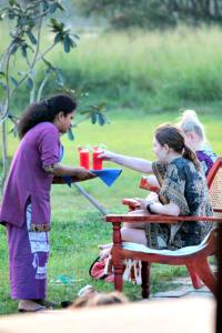 a group of people sitting at a picnic table at RHO Sigiriya Lake Edge Retreat & Spa in Sigiriya