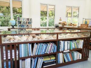 une bibliothèque avec des étagères remplies de livres et d'animaux farcis dans l'établissement Mirisbiris Garden and Nature Center, à Santo Domingo