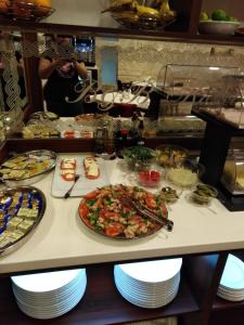 a buffet line with a plate of food on a table at Old Town Suites in Split