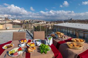 a table with plates of food on a balcony at Hotel Yesilpark in Istanbul
