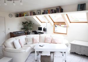 a living room with a white couch and a table at Westhinder in Wenduine