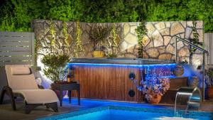 a swimming pool next to a wooden wall at Fiorentinos Villa in Tragaki +65 photos