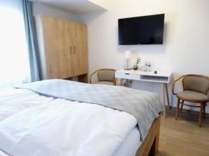Postel nebo postele na pokoji v ubytování Hotel Garni Villa Areka