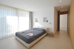 a bedroom with a bed with two white towels on it at VILLA BONITA - REF 216 in Begur +24 photos