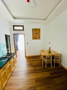 a kitchen and dining room with a table and chairs at Mỹ Lan hotel in Da Lat +11 photos