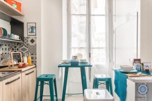 a kitchen with a table and a refrigerator at La Casa dei Treni Affittacamere city rooms for travel lovers in La Spezia