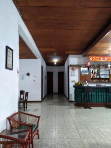 a hallway with chairs and a bar in a building at Hotel Olibert Parapat Ajibata Mitra RedDoorz in Parapat