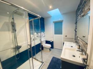 a bathroom with a shower and a sink and a toilet at Luxury Two Bed Seaviews in Puerto del Carmen