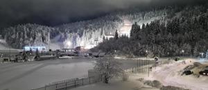 a snow covered ski resort with a snow covered slope at SL Apartment Bjelasnica in Bjelašnica
