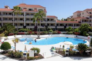 a large swimming pool in front of a large building at Hotel-Apartamentos Andorra in Playa de las Americas