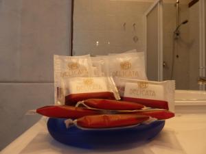three hot dogs on a blue plate in a bathroom at Antonella's Home in Cavallino-Treporti +26 photos