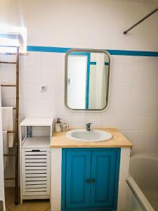 a bathroom with a sink and a mirror at Cabanas Terraces - Pool and seaview in Tavira +18 photos