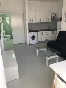 un soggiorno con divano e microonde di APARTAMENTO CENTRAL 1 a Corralejo