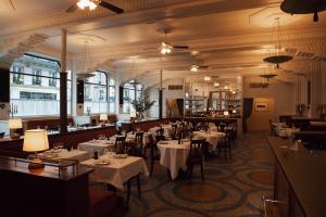 a restaurant with tables and chairs in a room at Hotel Rochechouart, Orso Hotels, a Member of Design Hotels in Paris