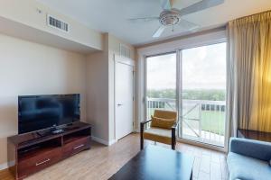 a living room with a flat screen tv and a large window at Sandestin Elation #5616 in Destin