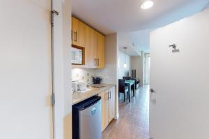 a kitchen with wooden cabinets and a counter top at Sandestin Elation #5616 in Destin