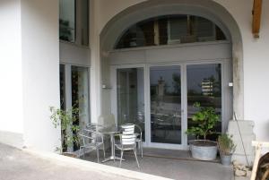 a patio with a table and chairs in front of a building at Carpe Diem - Bnb - Chambres d'hôtes in Péry