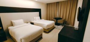 Posteľ alebo postele v izbe v ubytovaní Manazil Aldar Hotel