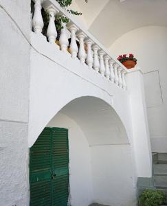 un edificio blanco con una puerta verde y escaleras en Il Vallone, en Crispiano