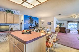 a kitchen and living room with a table with a bowl of fruit at Winter Garden House with Lanai and Pool Access! in Orlando
