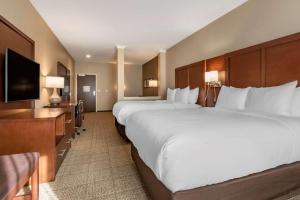 a hotel room with two beds and a flat screen tv at Comfort Suites Camp Hill-Harrisburg West in Harrisburg +21 photos
