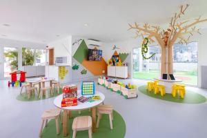 a room with a table and chairs and a tree at HD Parque Cristobal Tenerife in Playa de las Americas