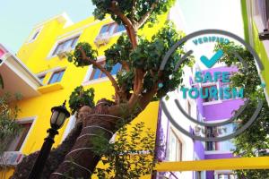 a tree in front of a building with a sign at The Zanadu İstanbul in Istanbul