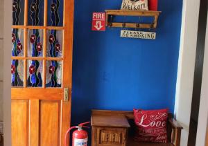 a room with a blue wall with a door at Guest House Mooigezicht in Clarens