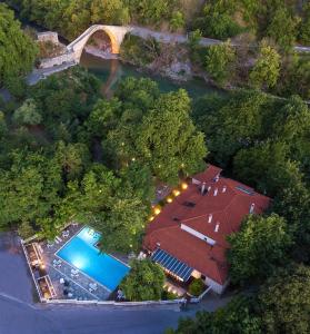 an overhead view of a house with a swimming pool at Κonitsa Gefyri hotel in Konitsa