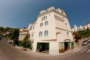a large white building on the side of a road at Hotel Bonadies in Ravello
