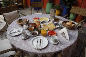 a table with a breakfast of food on it at Riad 7 Rijal Marrakech in Marrakesh