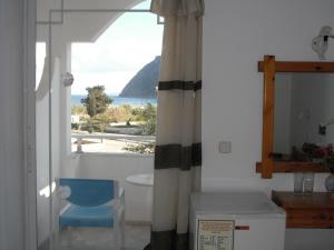 a room with a window with a view of the ocean at Antonis Hotel in Kefalos