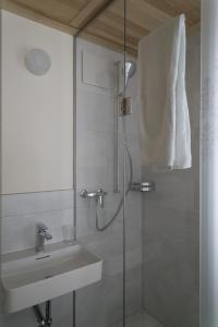 a bathroom with a shower and a sink at Hotel Erica in Langenbruck