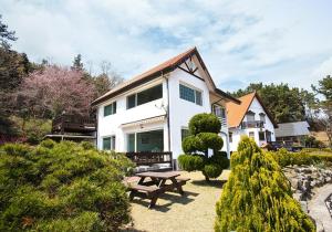 a house with a picnic table in front of it at Namhea German Village Beethoven House in Namhae