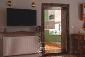 a living room with a flat screen tv on the wall at FLH - Luna Homes in Sibiu