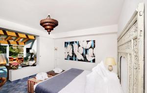 a bedroom with a bed and a living room at Le Calette Bay in Cefalù