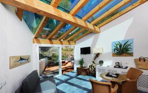 a living room with a vaulted ceiling and a table at Le Calette Bay in Cefalù