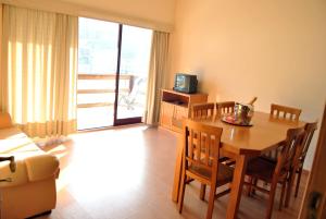 a dining room with a table and chairs and a television at Alojamento das Caldas in Caldas de Aregos