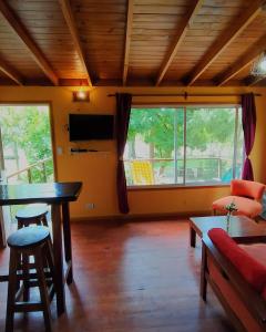 a living room with a table and a couch at Cabaña Sol de Medianoche Delta Tigre in Tigre
