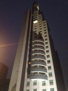 Flat no Itaim Bibi في ساو باولو: مبنى أبيض طويل وبه أضواء فوقه