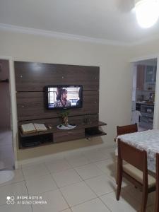 a television on a wall in a living room at Praia grande canto do forte top in Praia Grande +87 photos